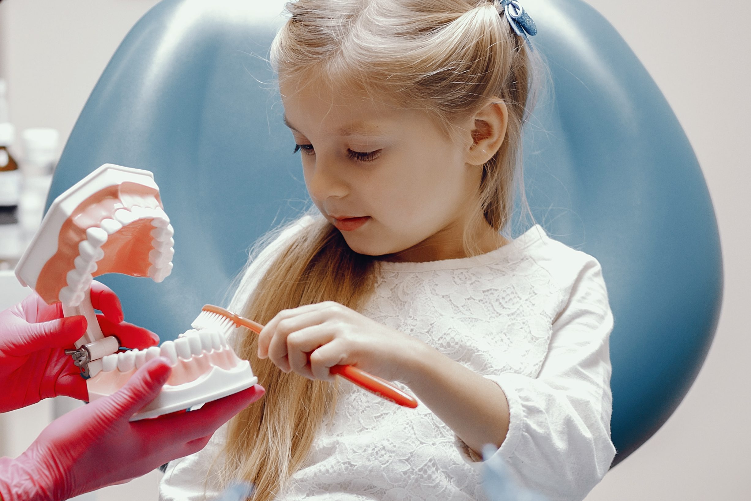 cute little girl sitting in the dentist